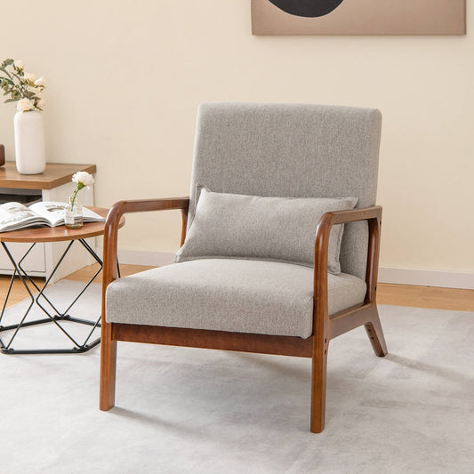 Grey fabric accent chair with wooden arms and legs in a living room setting