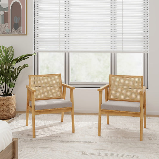 Two accent chairs with cane backs and grey cushions placed in a bright room with blinds