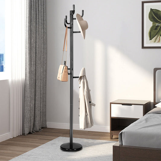 The coat rack in a bedroom, holding a hat, a handbag and a coat