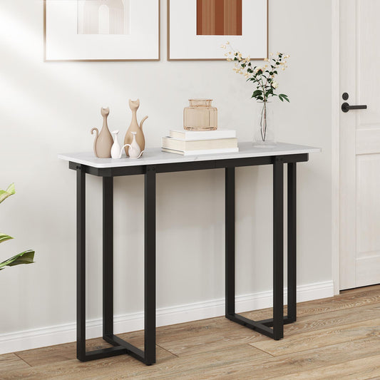 The console table is shown in a hallway with two framed pictures above