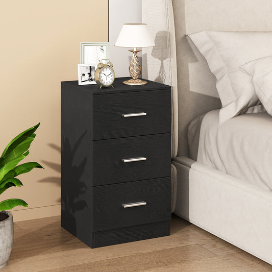 Black wood effect nightstand beside a bed with a lamp and photos on top