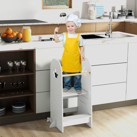 A young boy in a chef's hat and apron stands on the kitchen tower helping in the kitchen