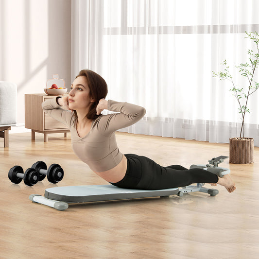 The sit up bench being used by a woman for back extension exercises in a bright room