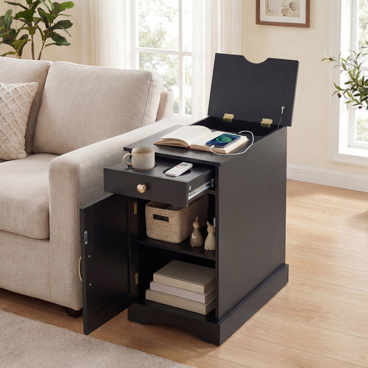 The black nightstand with the top lid open and the drawer pulled out beside a sofa