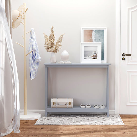 The grey console table is shown in a hallway with a suitcase, shoes and pictures on the wall