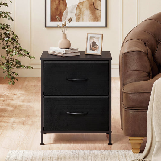 The black bedside table with two fabric drawers next to a sofa