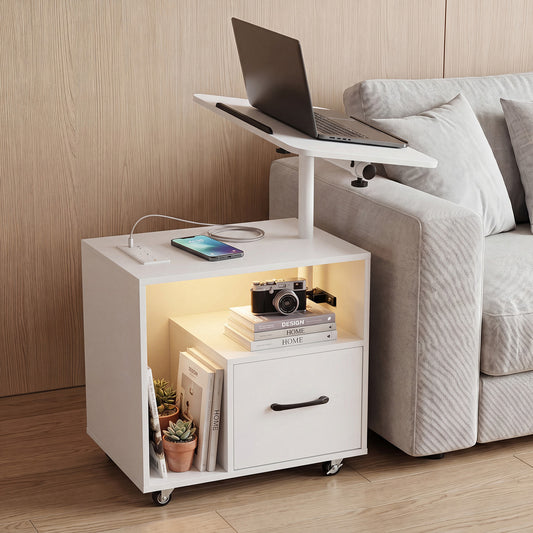 The white nightstand with charging station next to a sofa, with a laptop on its adjustable top