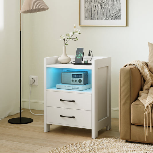 White bedside table with two drawers and LED lighting, shown in a living room setting next to a sofa
