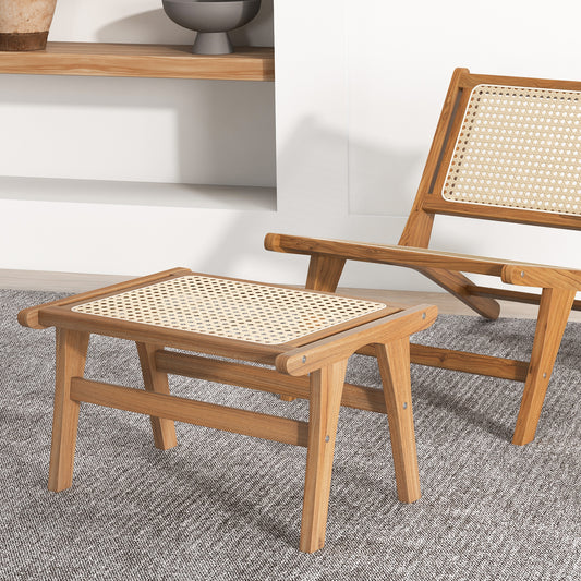 The wooden footstool placed on a grey rug next to a matching low chair in a bright room