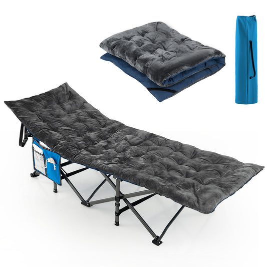 The dark grey camping cot pad is shown laid out on a camping cot, with a folded pad and blue bag nearby
