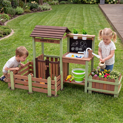 Two children playing together with the outdoor mud farm playset in a garden