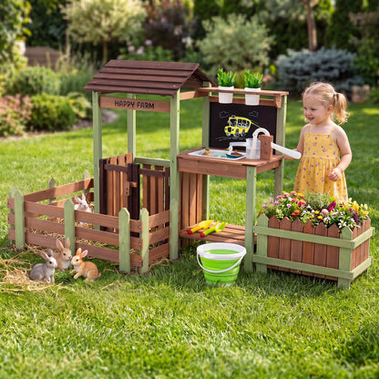 A young girl plays with the outdoor mud farm playset in a garden setting