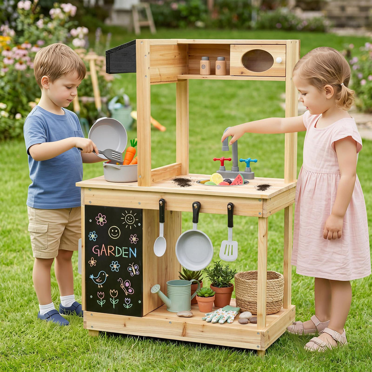 Two children playing with the wooden play kitchen set in a garden