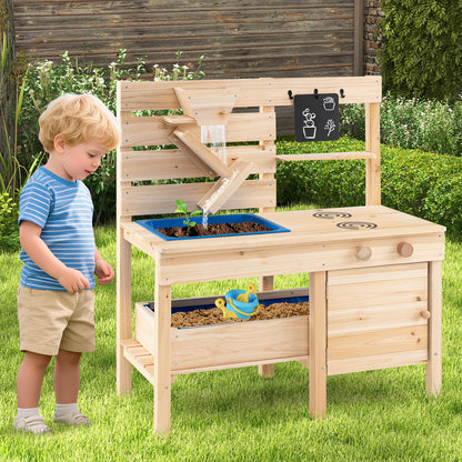 A young boy stands by the wooden play kitchen set in a garden setting