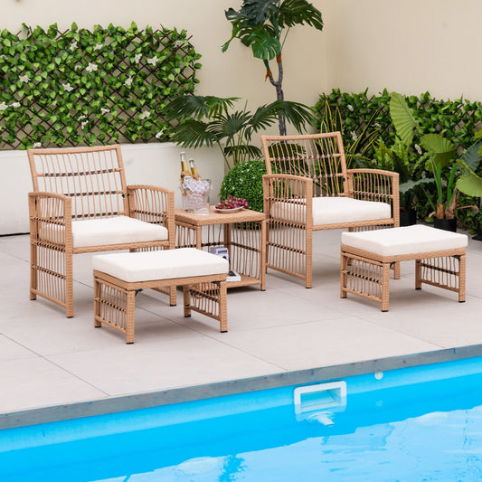 The rattan patio furniture set arranged on a tiled pool deck with tropical plants