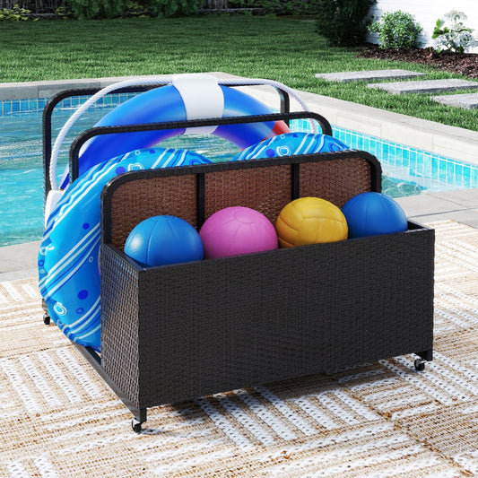 The storage organiser filled with colourful balls on a patio next to a swimming pool