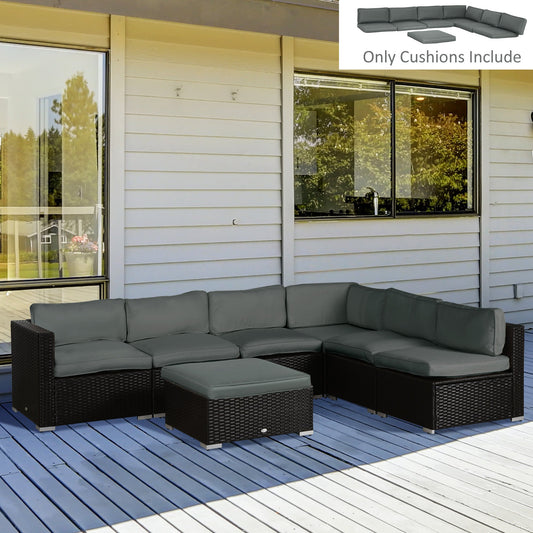 Grey dining set cushions arranged on a rattan furniture set on a wooden deck