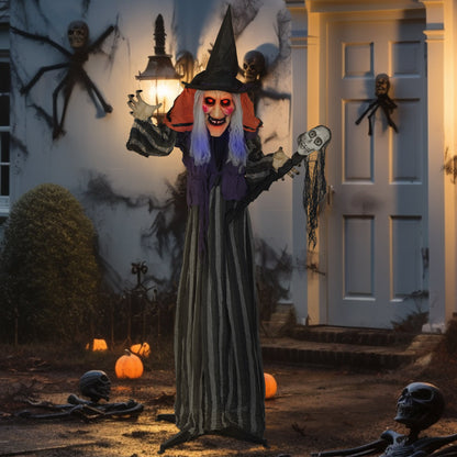 The Halloween witch decoration placed outside a house at night with spooky elements