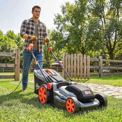 Man using the electric lawnmower to cut grass in a garden