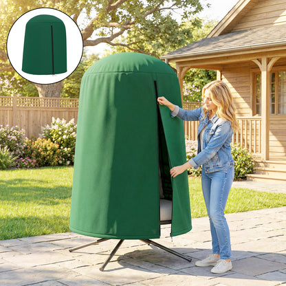A woman in a denim jacket zips up a green hanging egg chair furniture cover on a chair outdoors