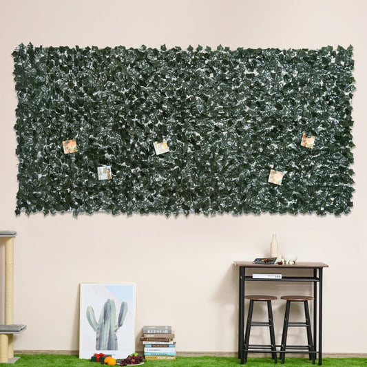 The artificial leaf fence panel used as a decorative wall covering indoors with pictures attached
