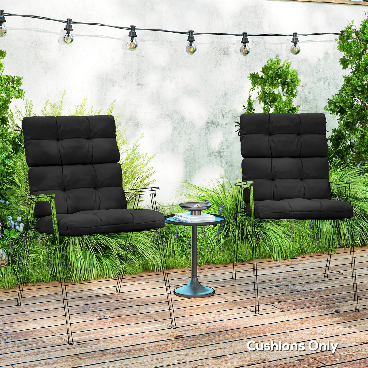 The garden chair cushions placed on outdoor chairs on a wooden patio with string lights
