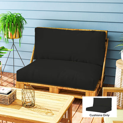The black seat and back cushions placed on a wooden pallet sofa on a patio