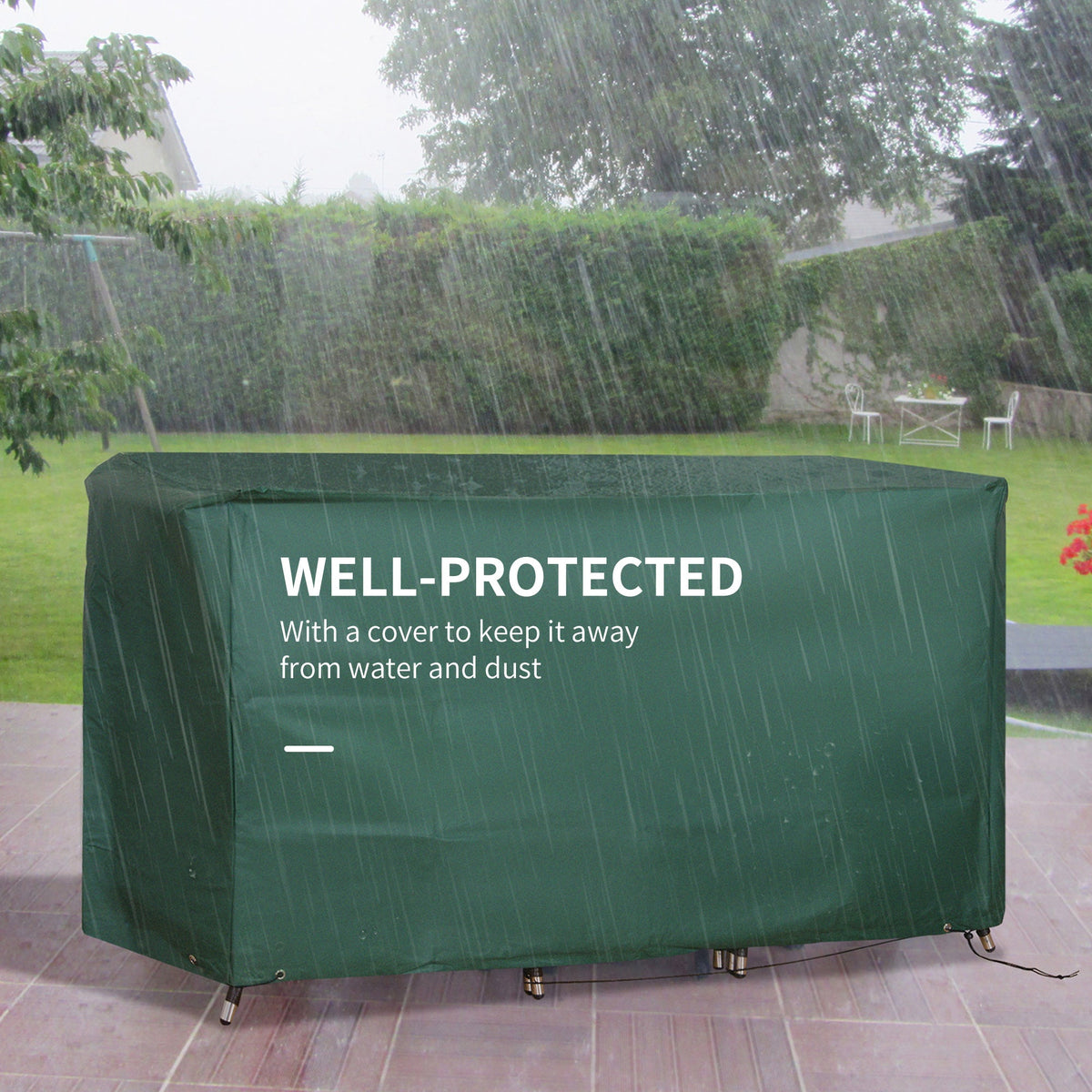 The rattan garden furniture set covered with a green waterproof cover in the rain
