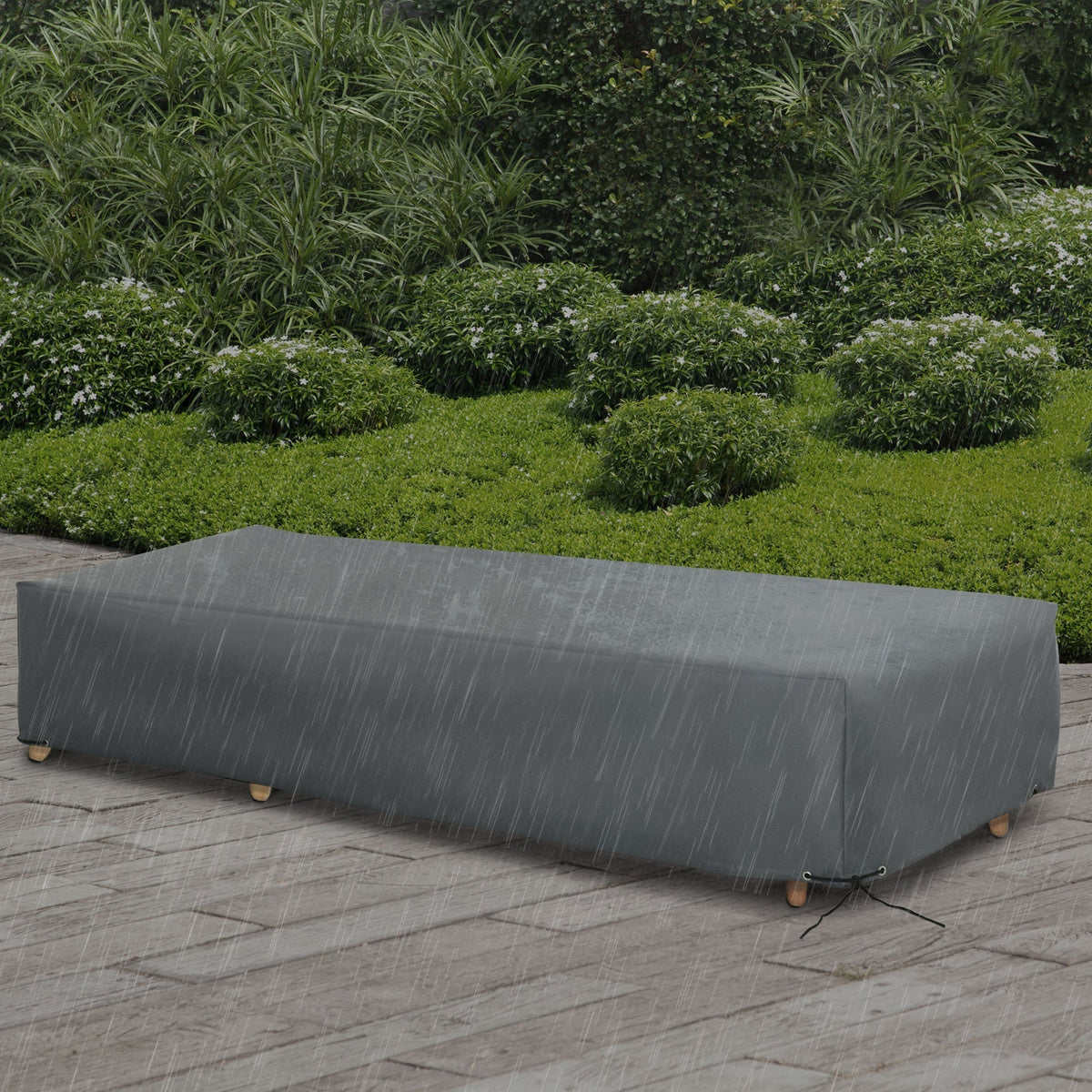The outdoor garden rattan furniture protective cover shown on a bench in a garden setting with rain falling