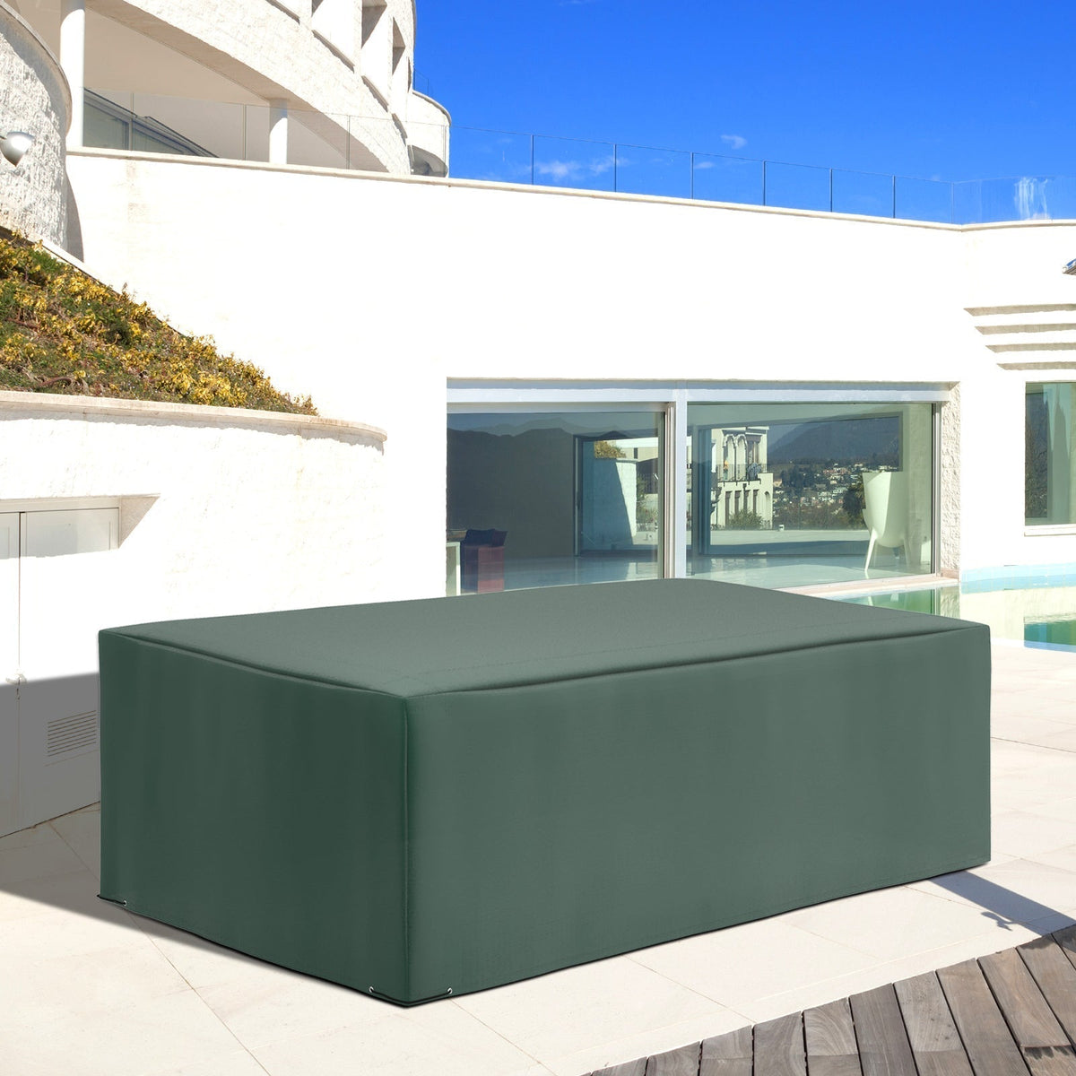 The garden furniture cover is shown protecting a large outdoor sofa set on a patio