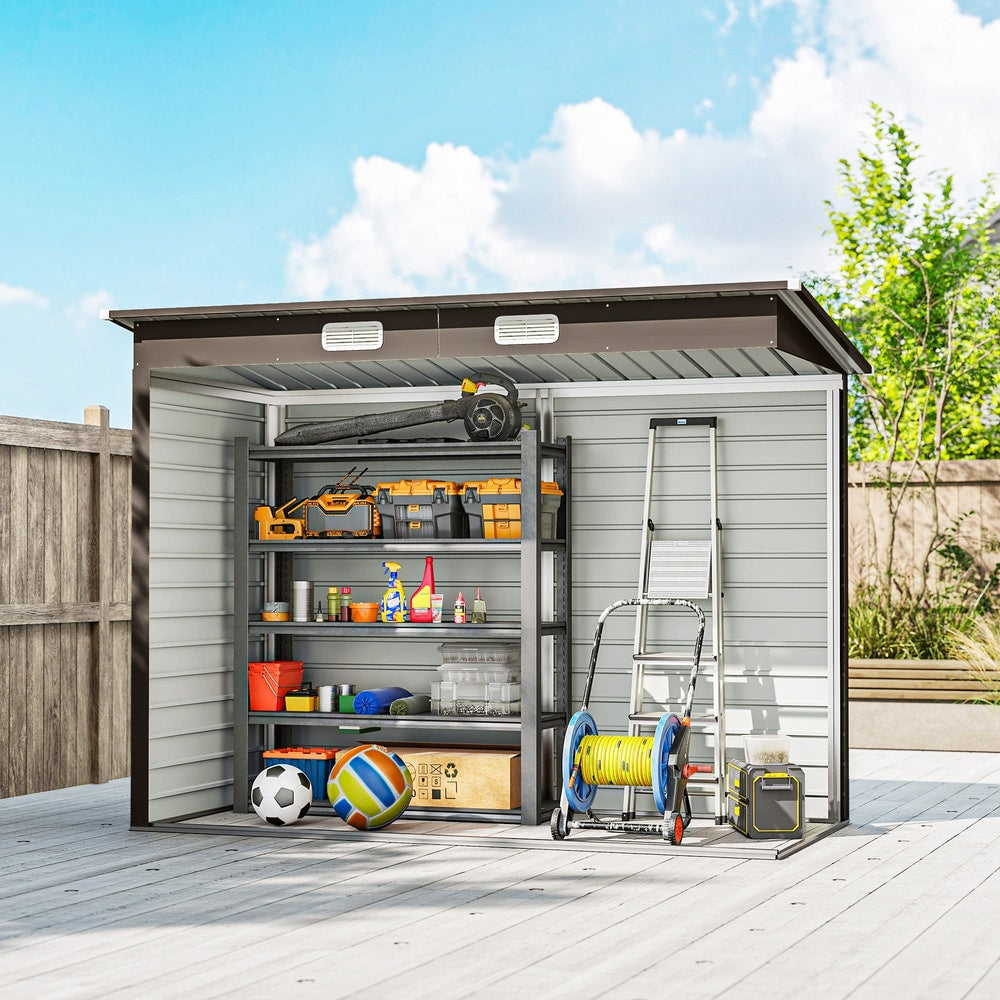 The garden shed interior organised with shelving units holding tools and garden equipment