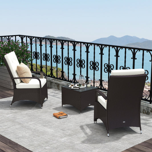 Two chairs and a coffee table set on a balcony with a sea view