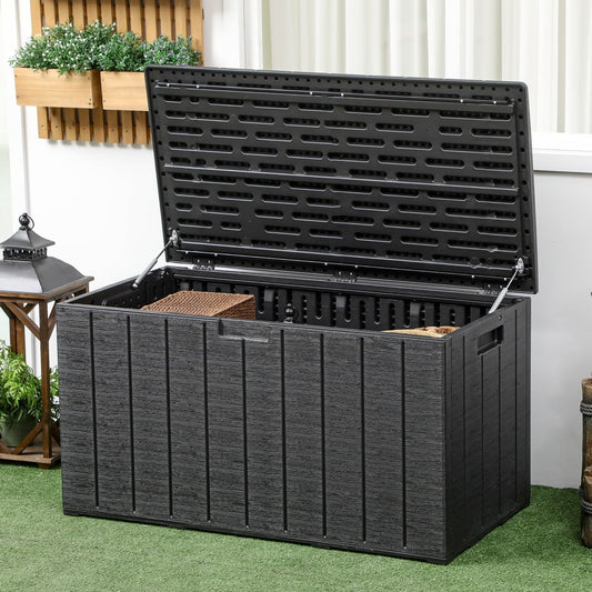The open garden storage box, showing its large capacity and contents like cushions and logs
