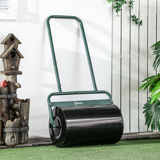 Dark green steel lawn roller with a black cylinder standing on artificial grass next to a wall