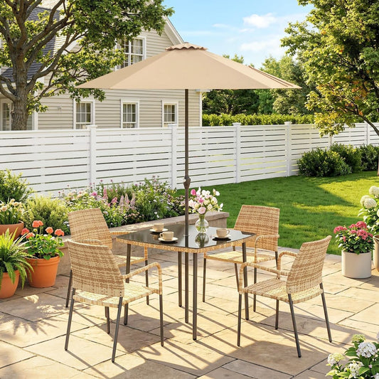 The rattan dining set with parasol arranged on a patio in a garden setting