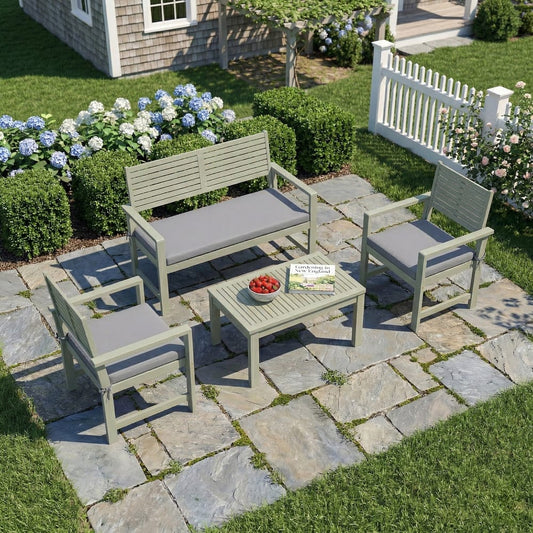 The garden furniture set arranged on a stone patio in a lush green garden