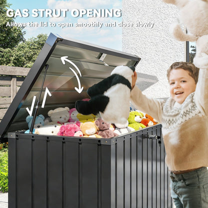Child adding toys to the black garden storage box with gas strut opening
