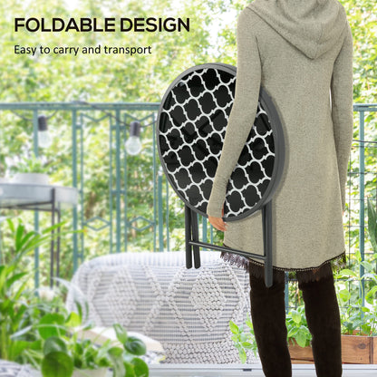 A person holding a round folding patio table, demonstrating its foldable design for easy storage