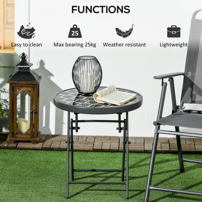 A round folding patio table with a patterned glass top and grey metal legs, displayed on a patio with decorative items