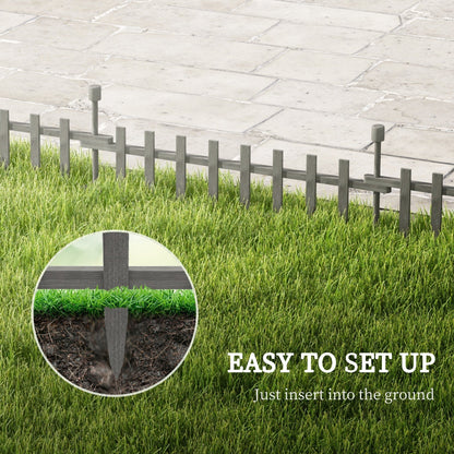 Close up of a grey wooden garden fence stake being inserted into the ground