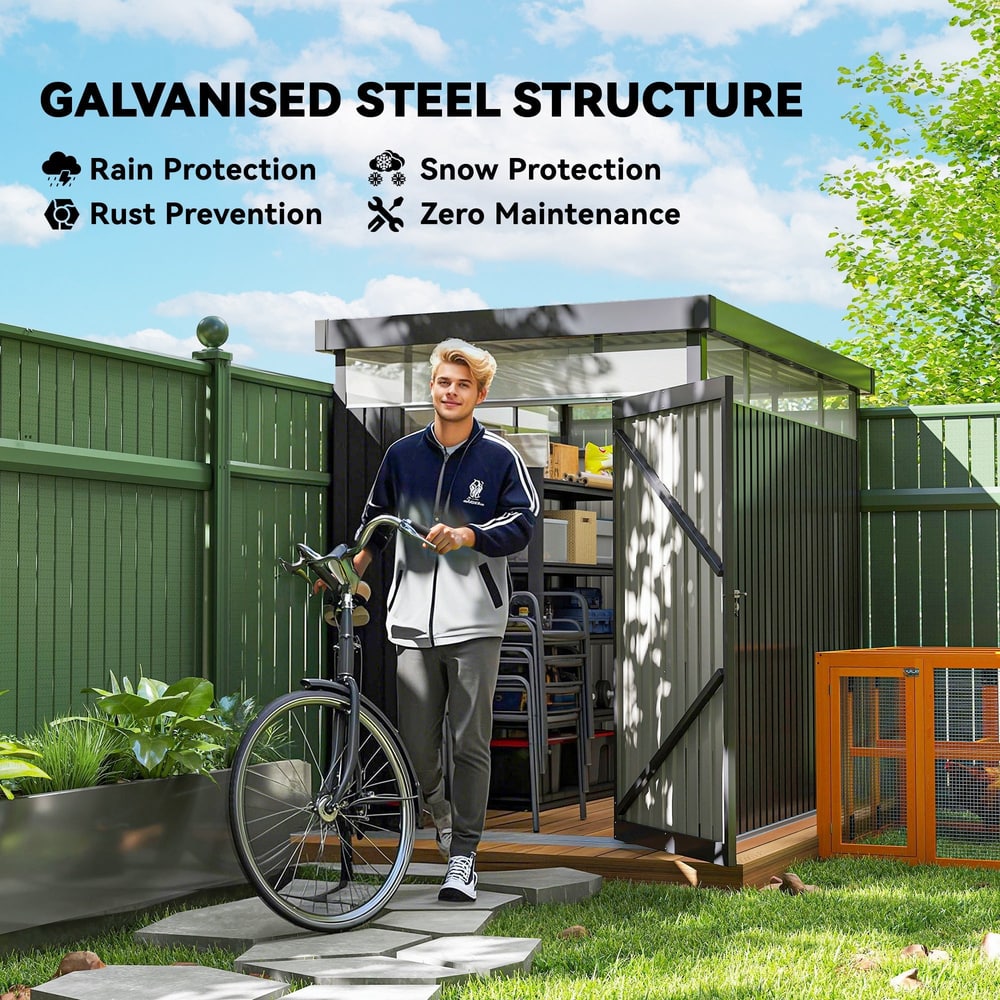 The garden shed in a backyard setting with a man standing in front holding a bicycle