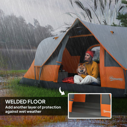 A woman and dog sit inside the orange and grey dome camping tent during light rain, showing the welded floor
