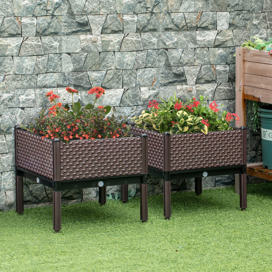 Two brown garden raised beds with flowers planted in them, set on grass