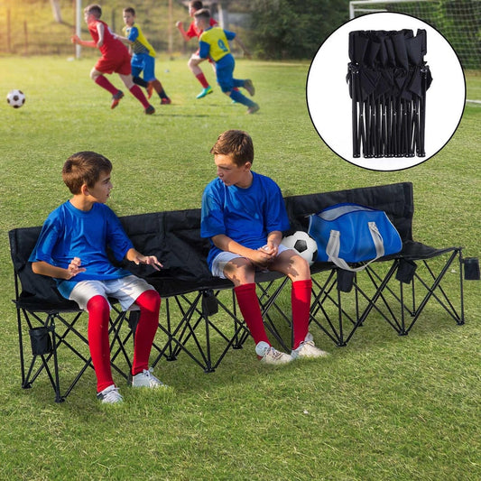 Two boys sitting on the black six seater folding camping chair at a football match