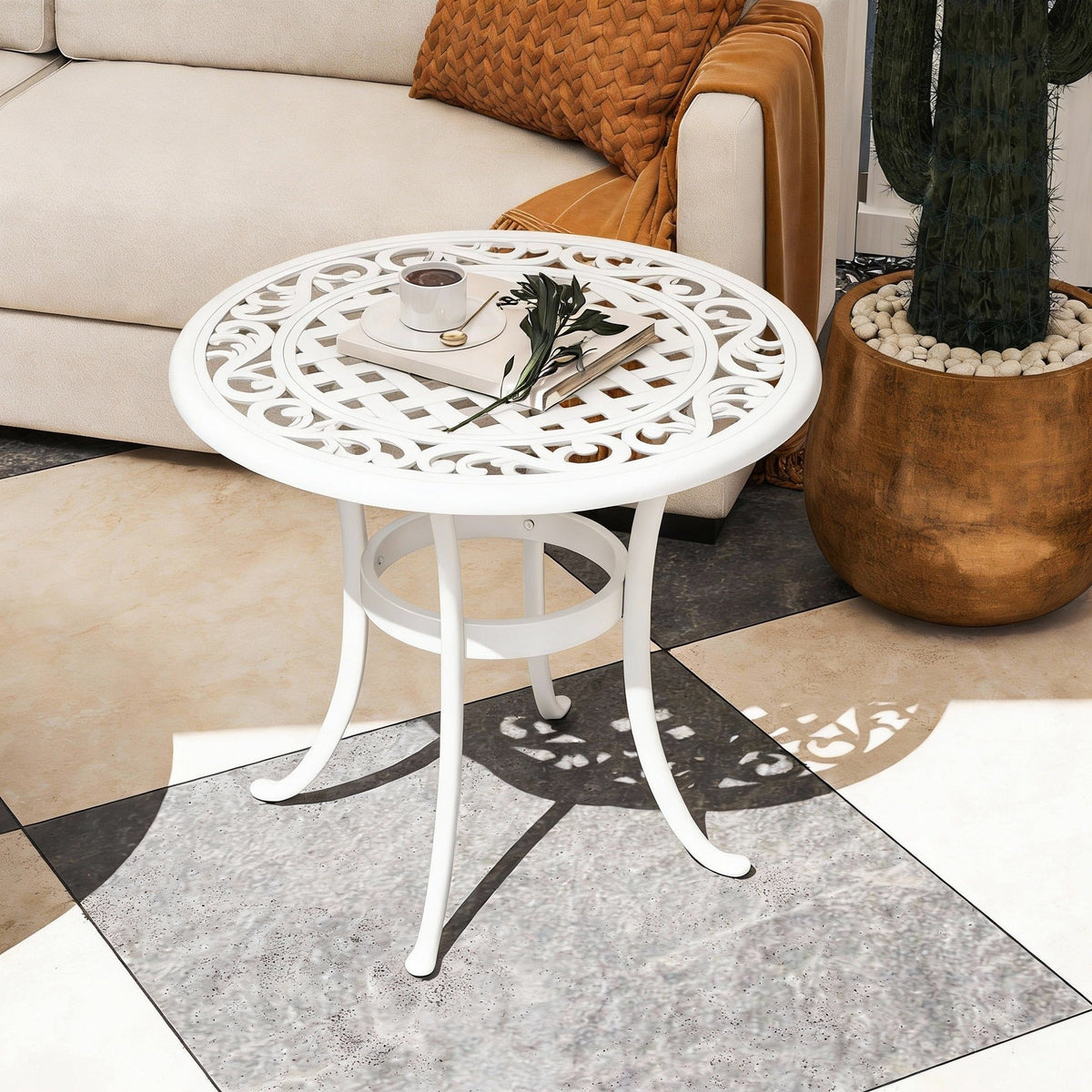 The garden table placed in a bright indoor living room next to a sofa and a large potted plant
