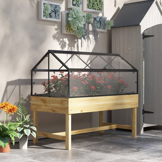 The wooden planter placed on a patio next to a shed with potted plants nearby