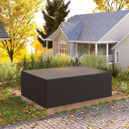 The black outdoor furniture cover is placed over a sofa set in an autumn garden setting