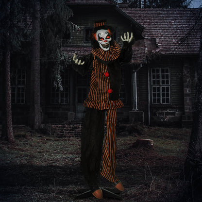 the scary clown decoration standing outside a spooky house at night