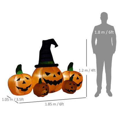 A large inflatable Halloween pumpkin wearing a hat, with four smaller pumpkins, shown with a person for scale