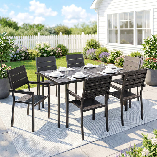 The garden dining set is arranged for six people on a patio with a house in the background